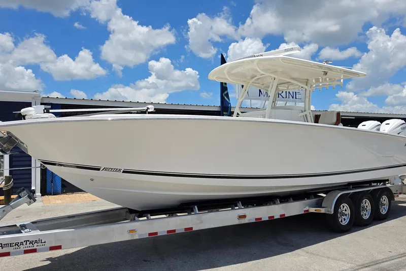 The Image of 2020 Jupiter 34 HFS boat on trailer under blue sky with clouds. - 1