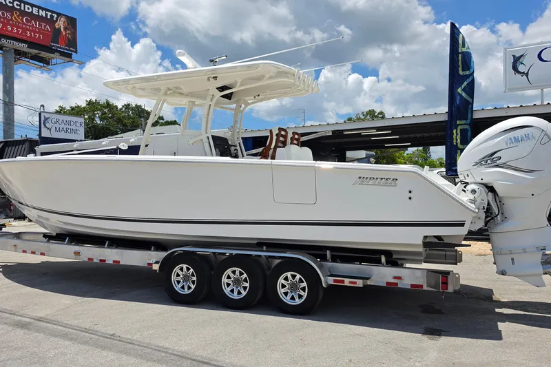 Slide: The Image of 2020 Jupiter 34 HFS boat on trailer with Yamaha engines, displayed outdoors. - 3