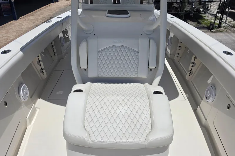 Slide: The Image of 2020 Jupiter 34 HFS boat interior with white diamond-stitched seating and cup holders. - 17