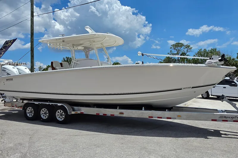 Slide: The Image of 2020 Jupiter 34 HFS boat on trailer under blue sky. - 7