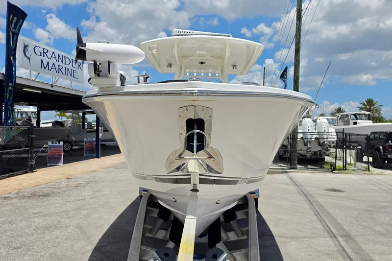 Slide: The Image of 2020 Jupiter 34 HFS boat at Grander Marine dealership under a blue sky. - 8