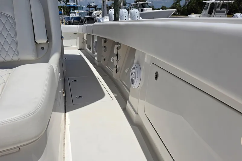 Slide: The Image of 2020 Jupiter 34 HFS boat interior with white seating and storage compartments. - 19