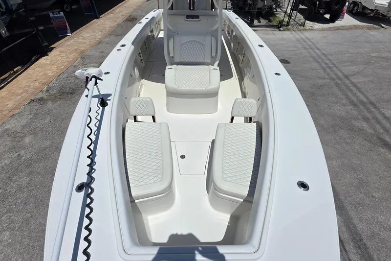 Slide: The Image of 2020 Jupiter 34 HFS boat interior with white cushioned seating and spacious deck. - 16