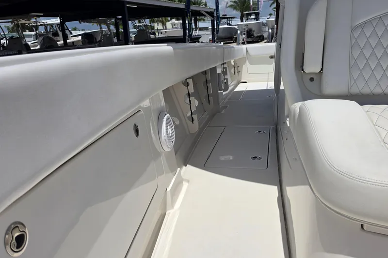 Slide: The Image of 2020 Jupiter 34 HFS boat interior with white seating and storage compartments. - 18