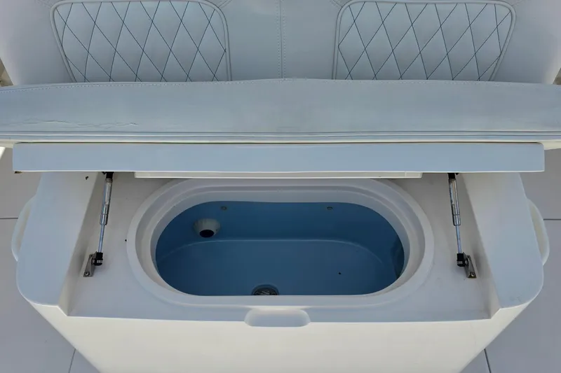 Slide: The Image of Open storage compartment on a 2020 Jupiter 34 HFS boat, featuring a blue interior. - 10