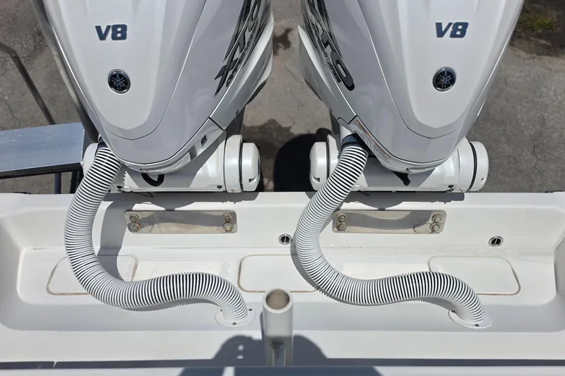Slide: The Image of Twin V8 outboard engines on a 2020 Jupiter 34 HFS boat, featuring coiled hoses. - 22