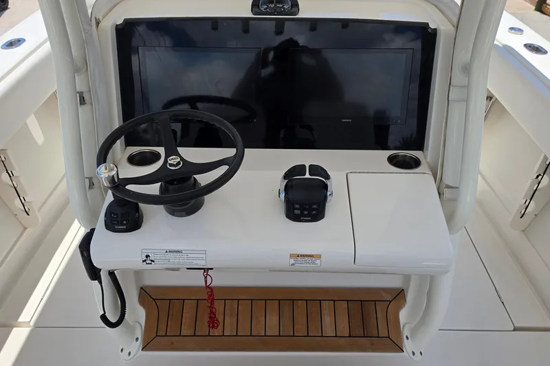 Slide: The Image of 2020 Jupiter 34 HFS boat helm with steering wheel, controls, and display screen. - 12
