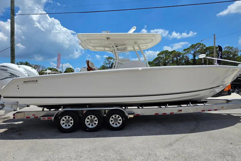 Slide: The Image of 2020 Jupiter 34 HFS boat on trailer under clear blue sky. - 6