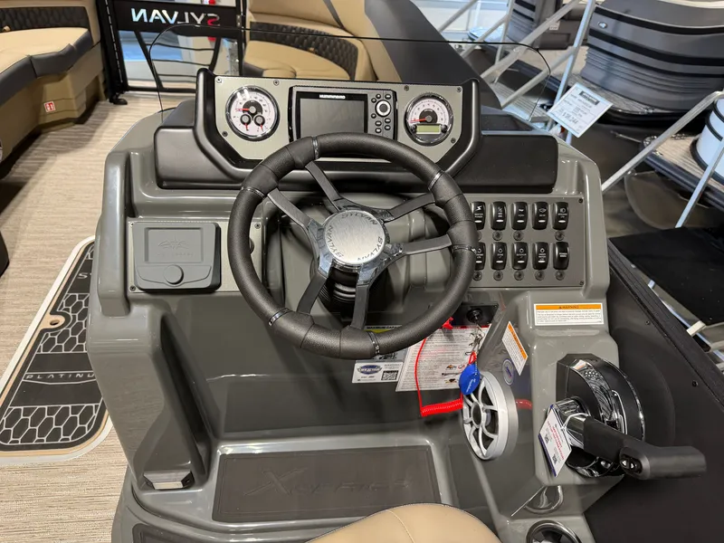 Slide: The Image of The image shows the helm of a Sylvan X5 DLZ DH BAR boat with modern instruments. - 12