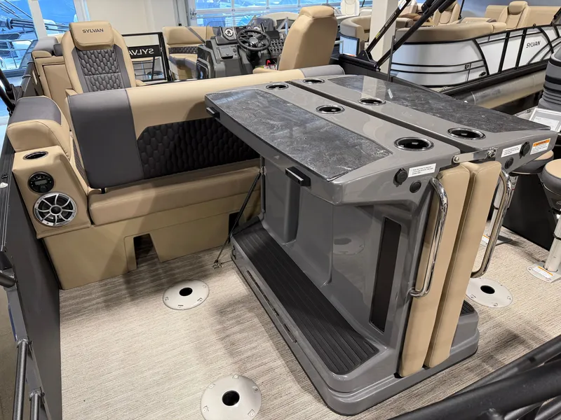 Slide: The Image of The image shows the interior of a 2027 Sylvan X5 DLZ DH BAR boat with a sleek bar and comfortable seating. - 20
