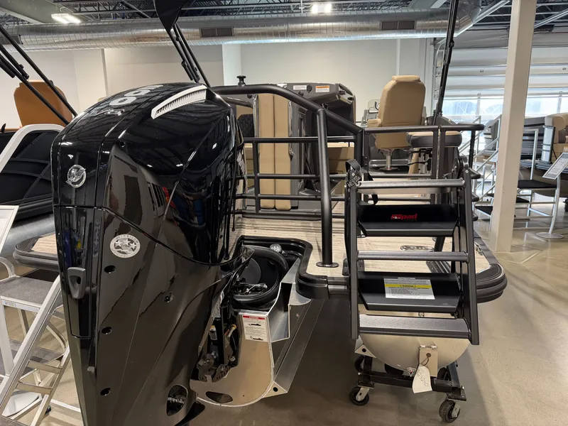 Slide: The Image of A 2027 Sylvan X5 DLZ DH BAR with a large outboard motor and a staircase to the deck. - 3