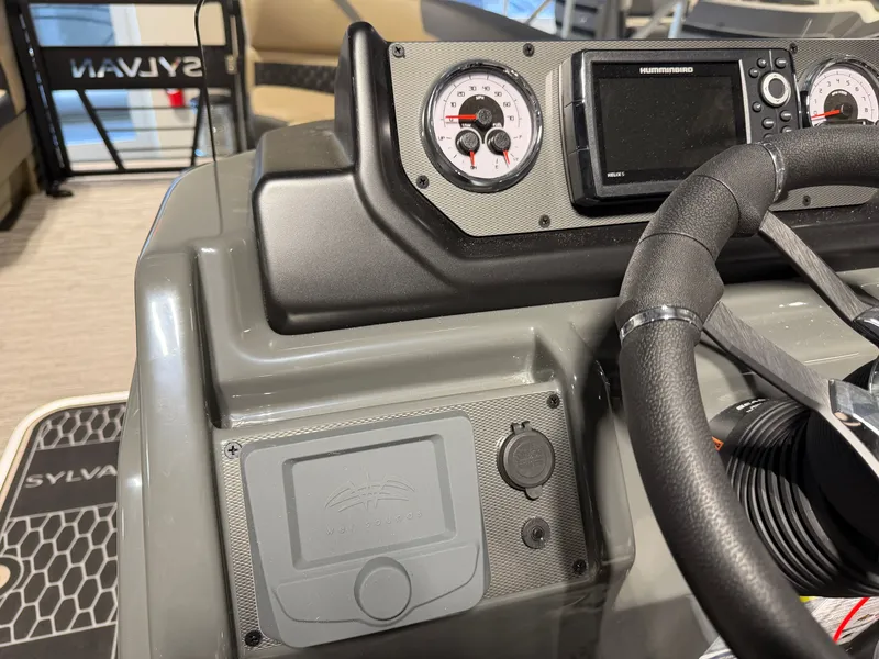 Slide: The Image of The image shows the helm of a Sylvan X5 DLZ DH BAR boat with modern instruments. - 13