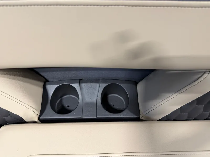 Slide: The Image of Close-up of two cup holders in a beige boat seat. - 7