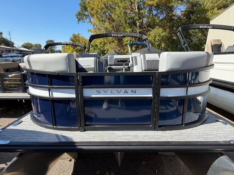 Slide: The Image of 2027 Sylvan X5 DLZ DH BAR with sleek blue paneling and gray seating outdoors. - 1