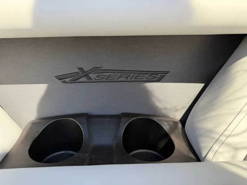 Slide: The Image of Close-up of two cup holders with "X Series" logo on a Sylvan boat. - 8