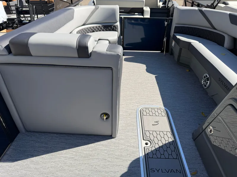 Slide: The Image of Interior of a 2027 Sylvan X5 DLZ DH BAR with gray upholstery and carpeted flooring. - 12