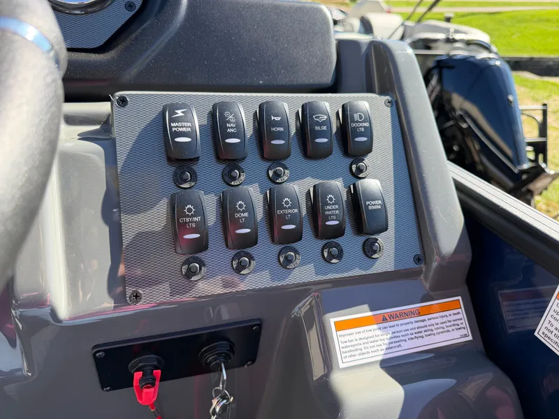Slide: The Image of Close-up of a boat control panel with various switches and a warning label. - 19