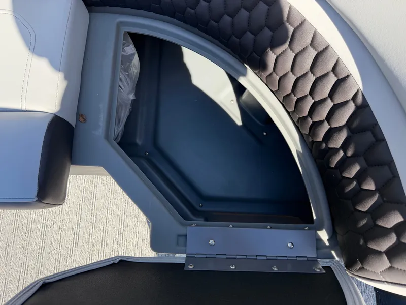 Slide: The Image of An open storage compartment with padded walls and a textured floor. - 9