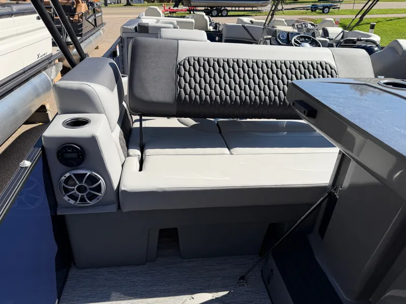 Slide: The Image of Sylvan X5 DLZ DH BAR 2027: Luxurious seating with speakers and an outdoor table. - 23