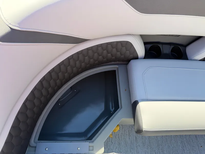 Slide: The Image of Close-up of a Sylvan X5 DLZ DH BAR boat seat with gray upholstery and cup holders. - 6