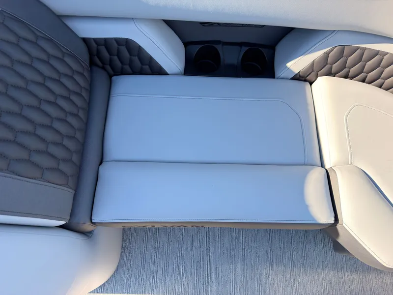 Slide: The Image of The image shows a luxurious boat seat with gray and white upholstery and cup holders. - 15