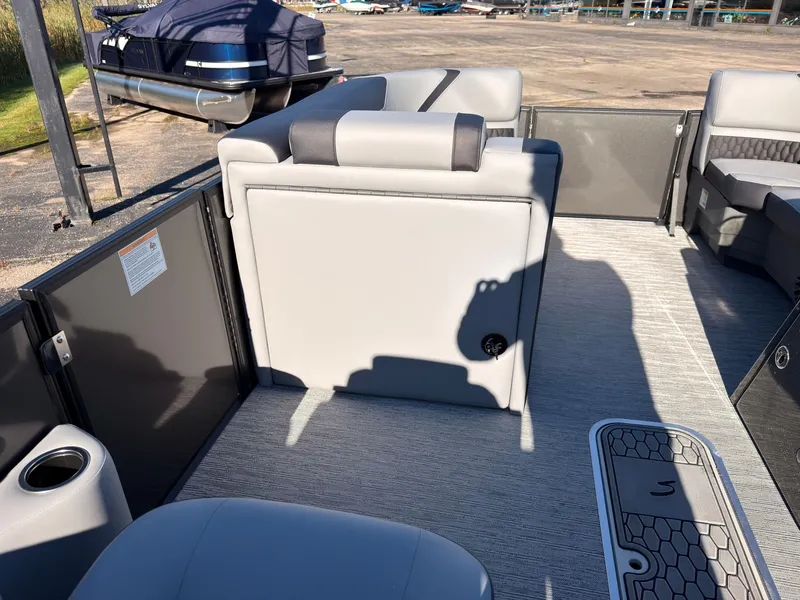 Slide: The Image of The image shows the interior of a 2027 Sylvan X3 LZ DH boat with gray upholstery. - 35
