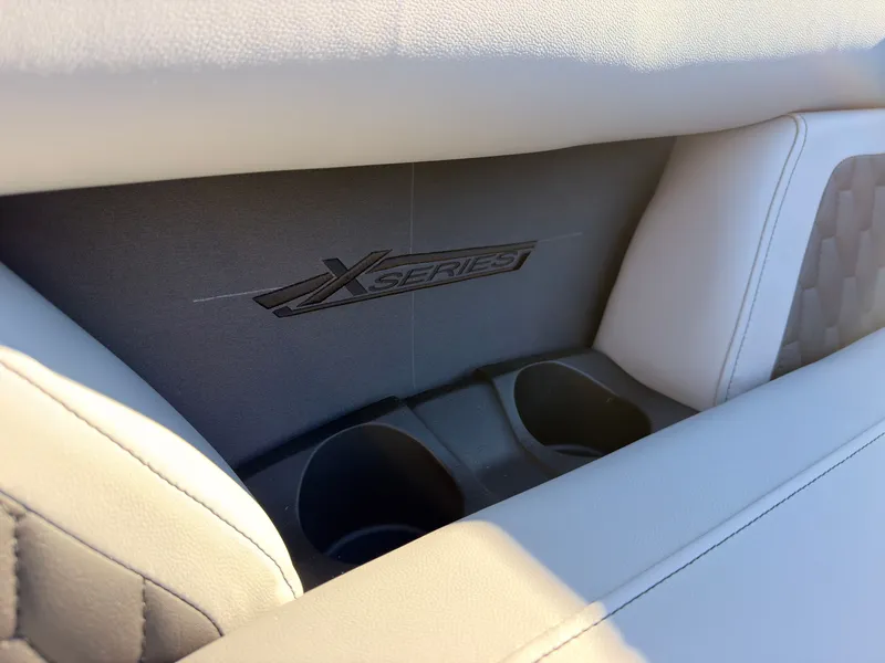 Slide: The Image of Close-up of a boat seat with "X Series" logo and cup holders. - 26