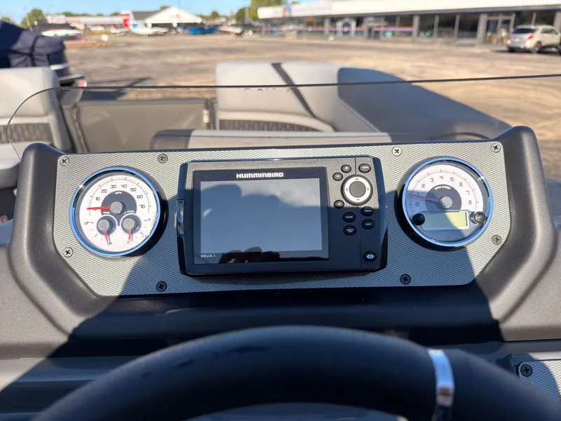 Slide: The Image of The dashboard of a 2027 Sylvan X3 LZ DH with a Humminbird display and two round gauges. - 42