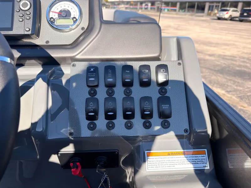 Slide: The Image of The image shows the dashboard of a Sylvan X3 LZ DH boat with various switches. - 43