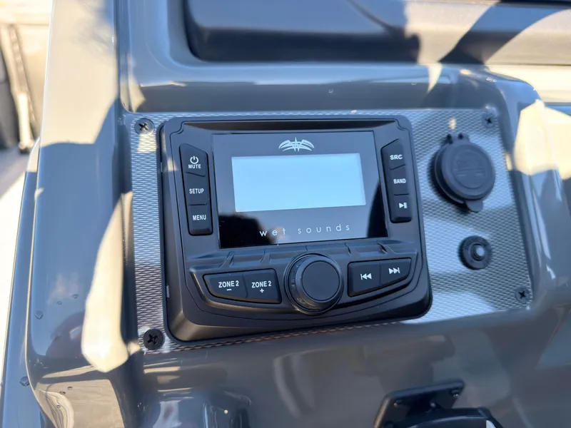 Slide: The Image of Close-up of a modern boat audio system with multiple controls and a digital display. - 41