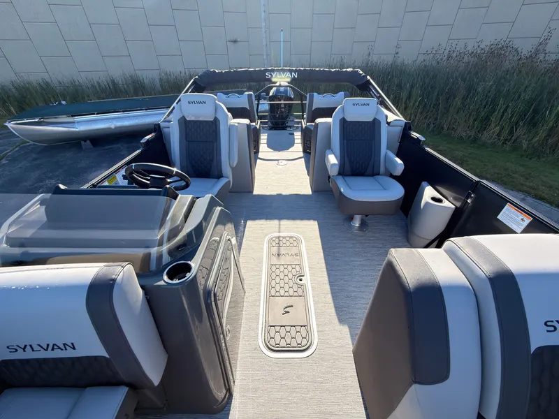 Slide: The Image of The image shows the interior of a 2027 Sylvan X3 LZ DH boat with luxurious seating. - 27