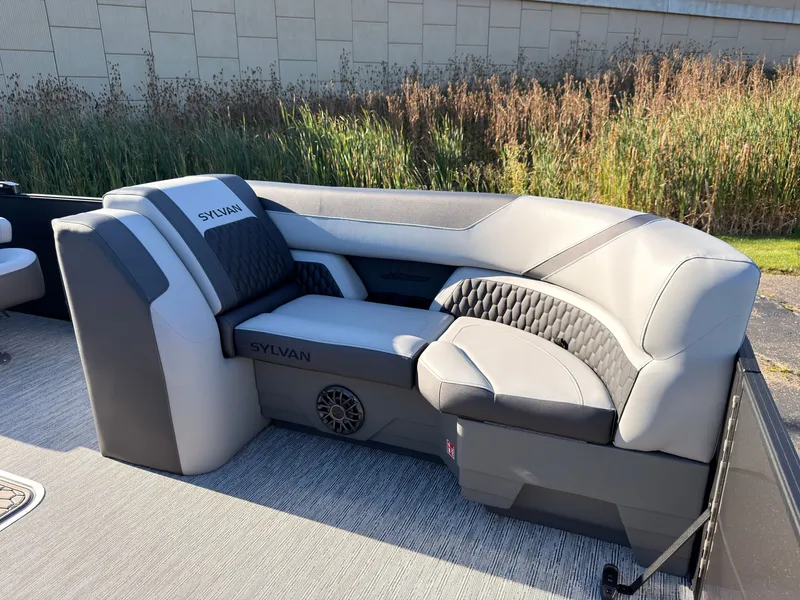 Slide: The Image of The image shows a luxurious, cushioned seating area on a Sylvan X3 LZ DH boat. - 11