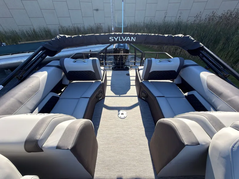 Slide: The Image of The image shows the interior of a 2027 Sylvan X3 LZ DH with gray seating and a Bimini top. - 49