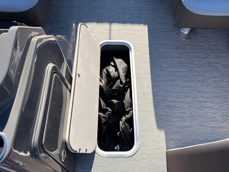 Slide: The Image of An open storage compartment on a boat with black fabric inside. - 31