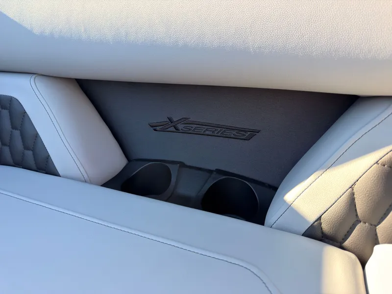 Slide: The Image of Close-up of a boat seat with "X-Series" logo and two cup holders. - 17
