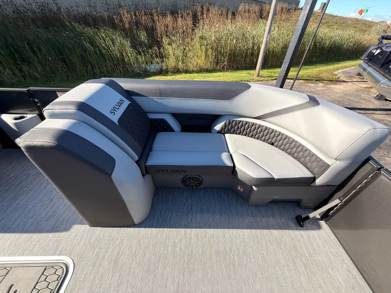 Slide: The Image of The image shows a modern, gray seating area on a Sylvan X3 LZ DH boat. - 12
