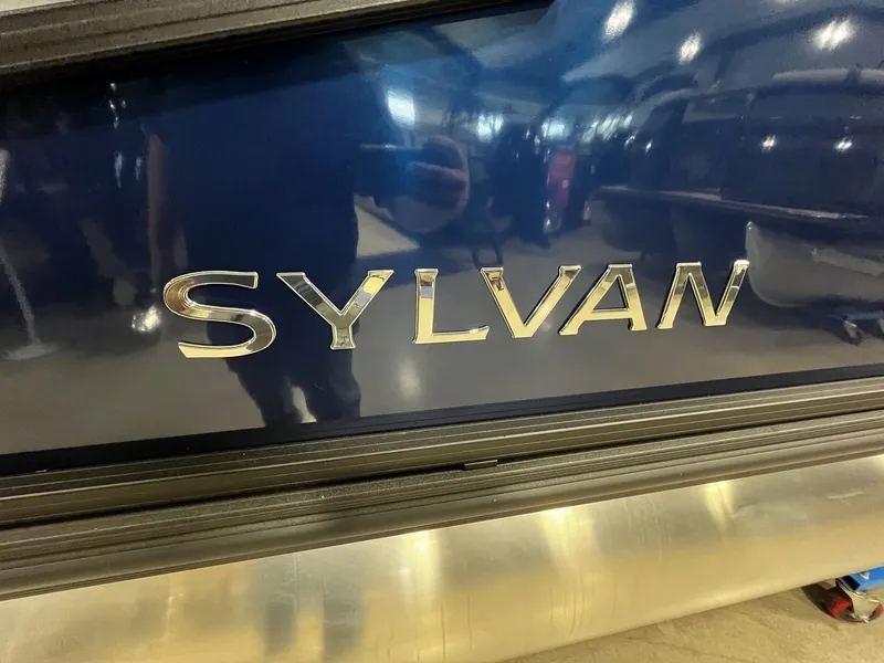 Slide: The Image of Close-up of the Sylvan logo on a shiny blue boat. - 23