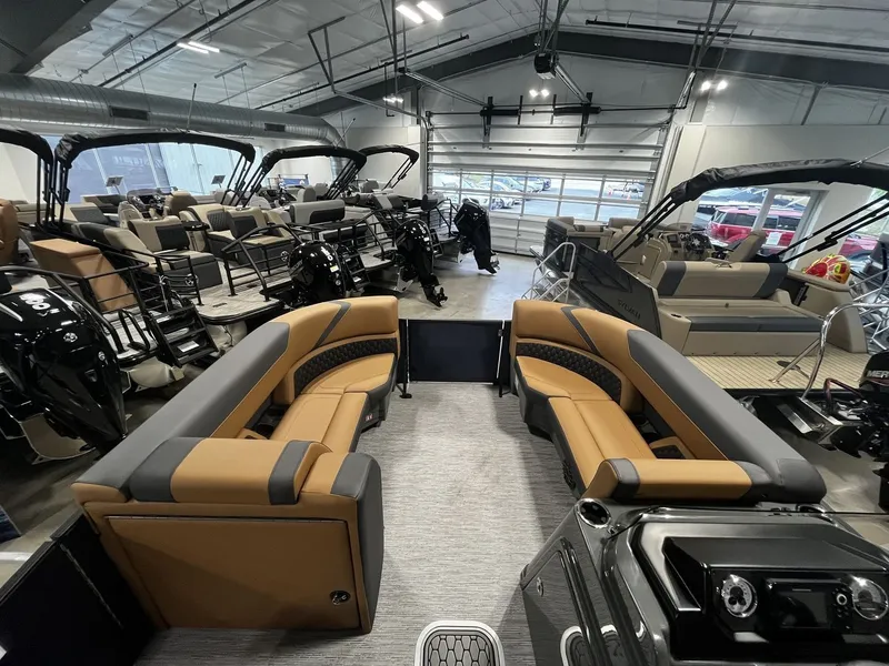 Slide: The Image of Interior view of a 2027 Sylvan X3 LZ DH with luxurious seating in a showroom. - 9