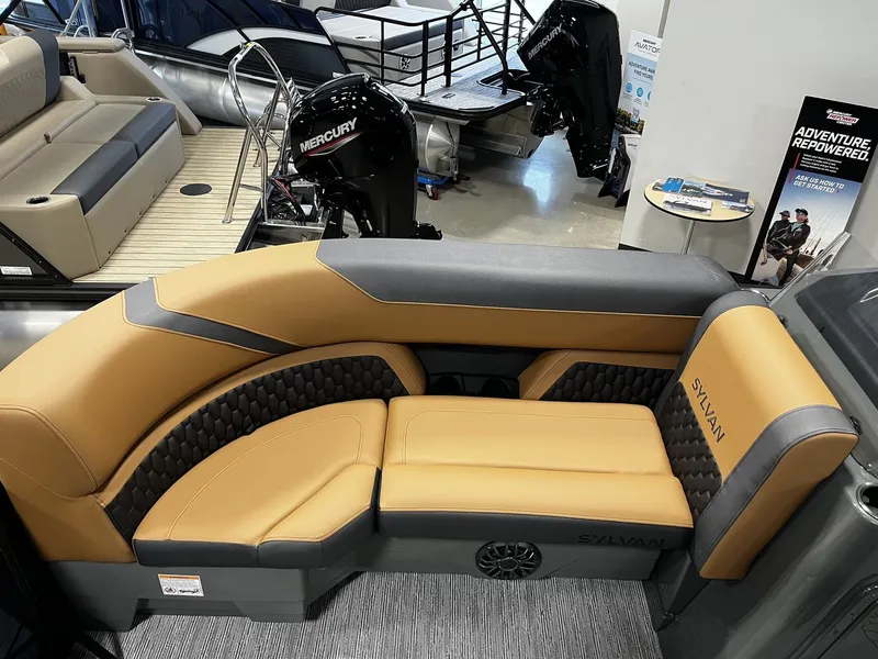 Slide: The Image of The image shows a luxurious seating area on a Sylvan X3 LZ DH boat, surrounded by modern engines. - 6