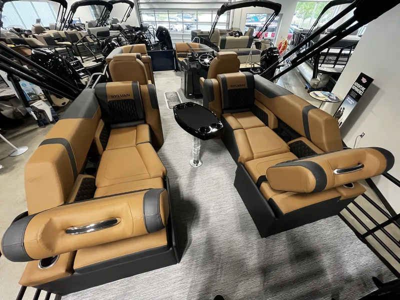Slide: The Image of Interior of a 2027 Sylvan X3 LZ DH with luxurious brown leather seating and a small table. - 16