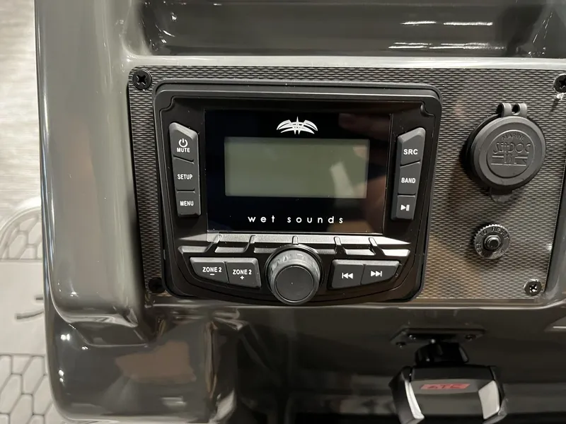 Slide: The Image of Close-up of a modern boat sound system with multiple controls and a display. - 12