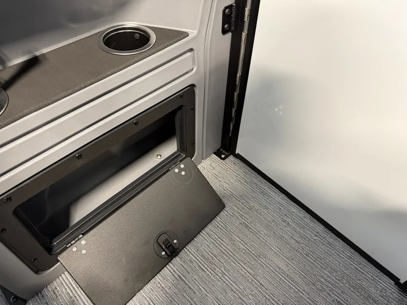 Slide: The Image of Interior of a 2027 Sylvan R-20 CLZ DH with gray carpeting and storage compartment. - 19