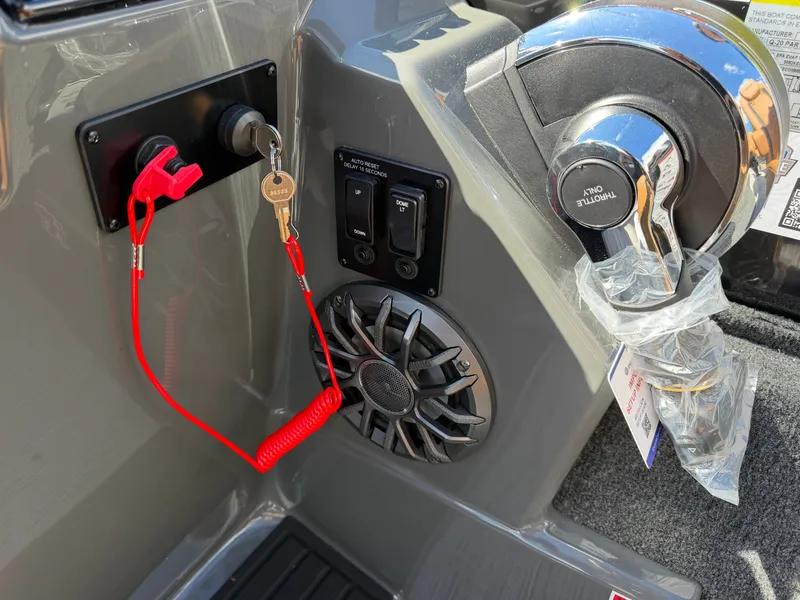 Slide: The Image of Close-up of a Sylvan Q-20 Party Fish console with ignition key and speaker. - 18
