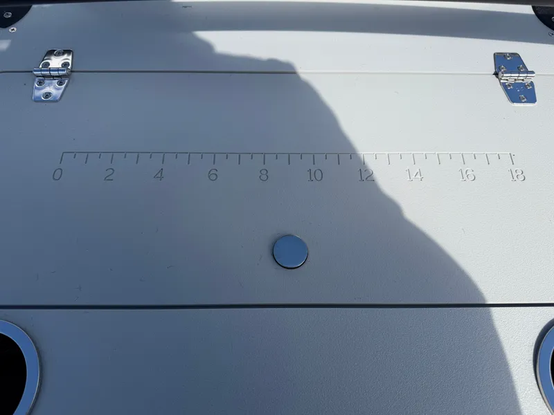 Slide: The Image of A boat with a measuring ruler on the surface, two cup holders, and hinges. - 24