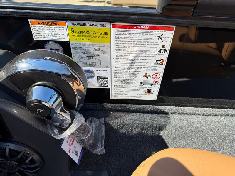 Slide: The Image of Close-up of the control area on a Sylvan Q-20 Party Fish boat with warning labels. - 15