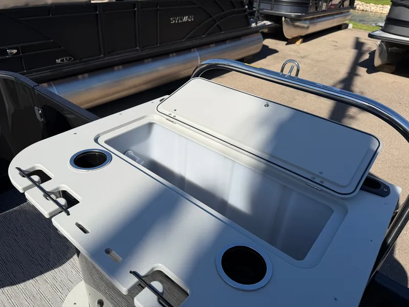 Slide: The Image of The image shows part of a Sylvan Q-20 Party Fish boat with cup holders and storage space. - 24
