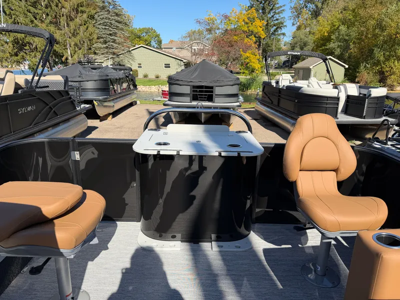 Slide: The Image of The image shows the interior of a Sylvan Q-20 Party Fish boat with beige seats and a table. - 22