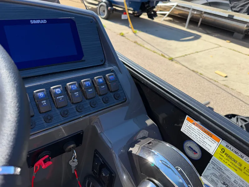 Slide: The Image of The image shows the dashboard of a Sylvan Q-20 Party Fish boat with various controls. - 14