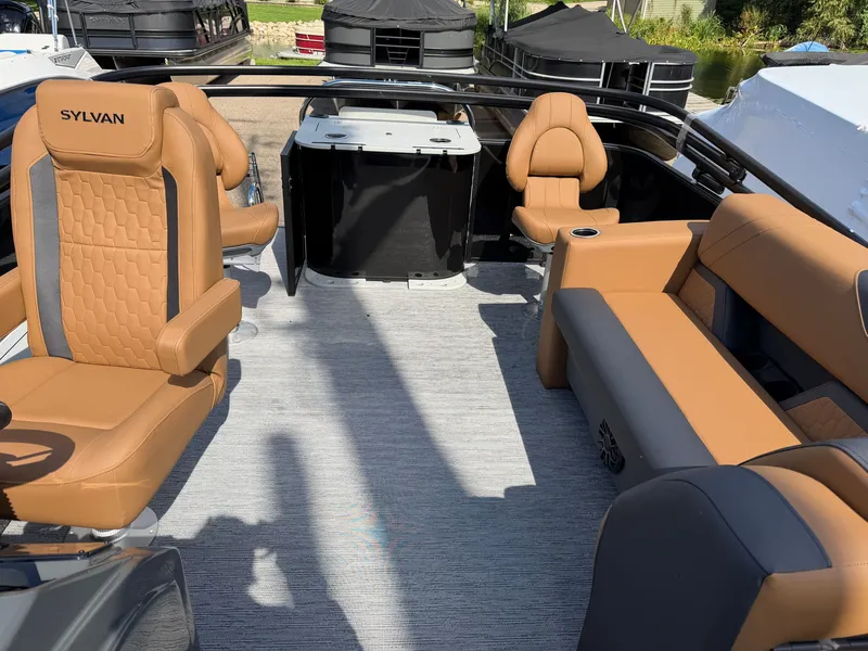 Slide: The Image of The image shows the interior of a 2027 Sylvan Q-20 Party Fish boat with beige seating. - 26