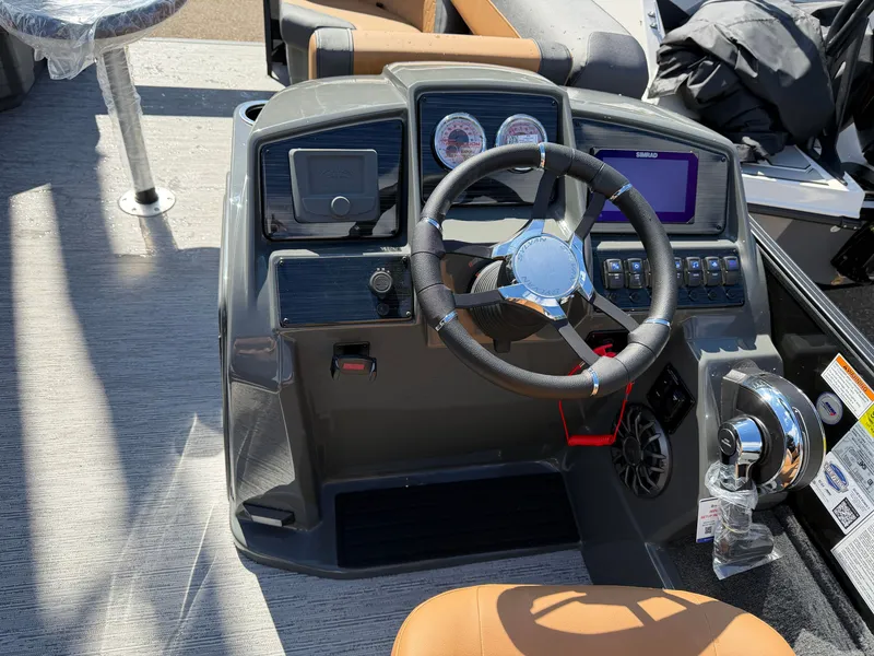 Slide: The Image of The image shows the helm of a Sylvan Q-20 Party Fish boat with modern instruments. - 14